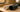 Two large PVC pipes, black and white, on a wooden van interior surface
