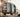 Custom Sprinter camper van with open doors, outdoor setting, dog and firewood nearby