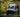 Custom Sprinter camper van with roof lights parked in a forest setting, adventure ready