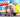 Woman posing by custom Sprinter van with open rear doors on sunny outdoor road