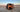 Custom camper van with open doors parked on a salt flat at sunset, mountains in distance