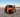 Custom camper van with open doors parked on a salt flat at sunset, mountains in distance