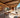 Modern custom camper van interior with cozy seating, wood finishes, desert view