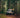 Sprinter adventure van parked in forest, person in yellow jacket on ladder, dog nearby