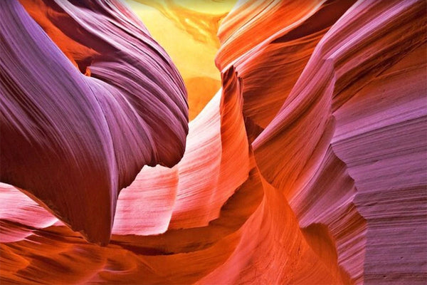 Colorful Antelope Canyon sandstone rock formations with sunlight highlighting vibrant layers