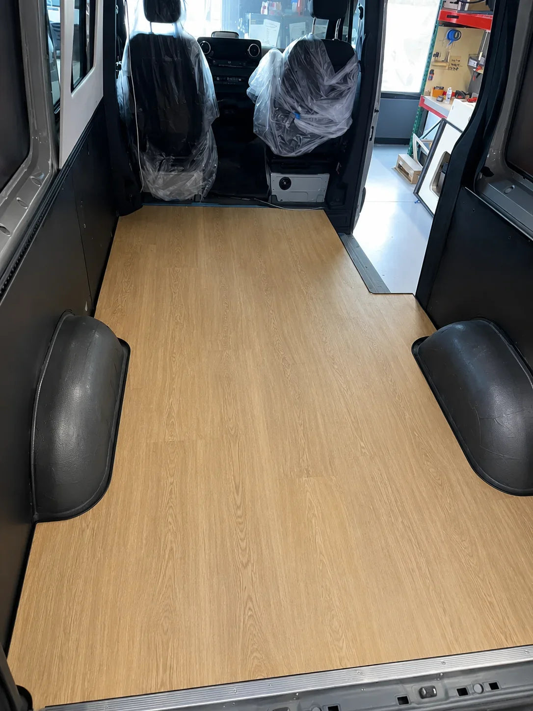 Farmhouse Oak one-piece vinyl floor installed in a Mercedes Sprinter 144 cargo area at the Sandy Vans shop in San Diego