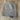 Gray knit beanie with Sandy Vans logo on wooden floor