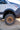 Rugged off-road tire and bronze wheel on a custom Sprinter van for adventurous builds