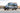 Custom off-road Sprinter van with roof rack, LED lights, and rugged tires in desert setting