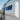 Custom Sprinter van side window with exterior ladder and smooth white paneling