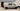 Custom Sprinter van with roof rack and off-road tires, ready for adventure in San Diego.