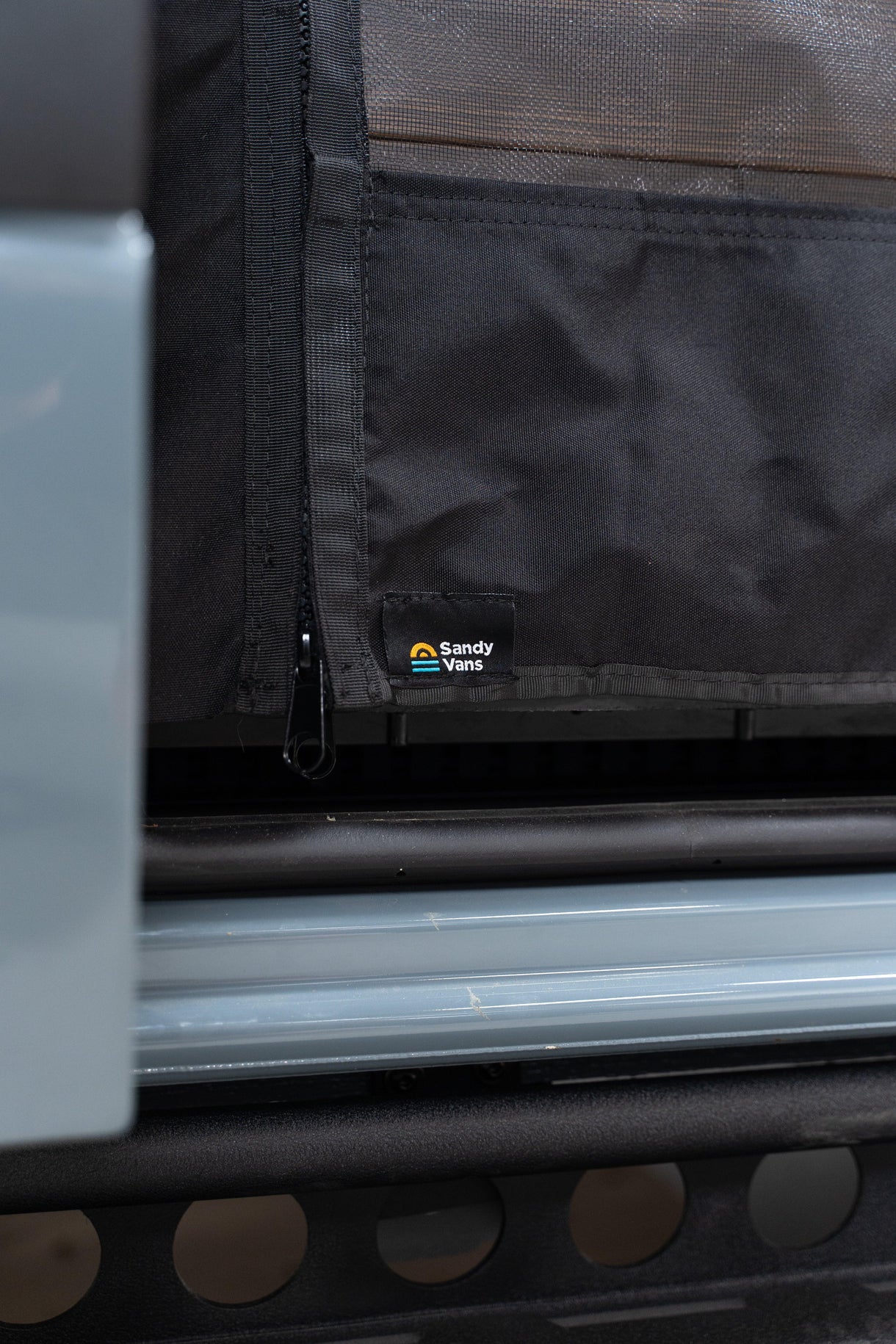 Sandy Vans slider door bug screen installed on a Mercedes Sprinter