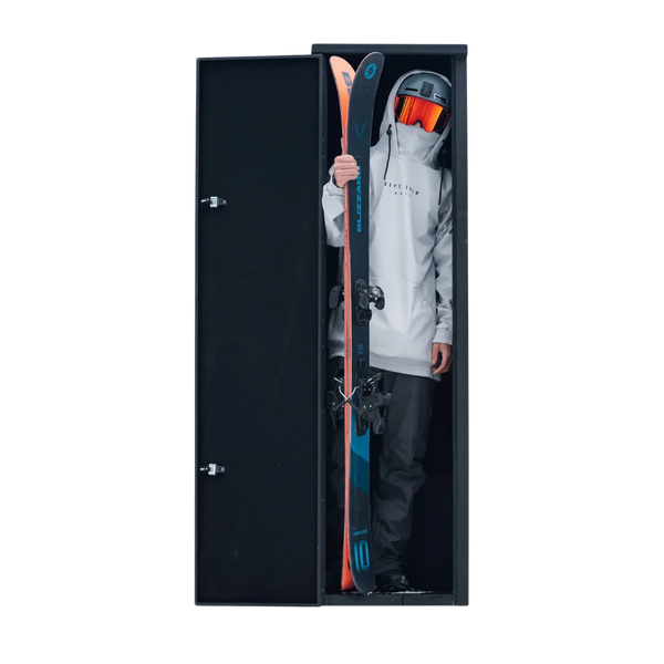 Boost Box tall rear locker open on a black backdrop with a skier standing inside beside upright skis