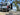 Custom Sprinter VS30 adventure van with SV Spare Tire Rack at scenic overlook — driver-side rear door spare tire mount