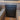 Black camper van shower pan installed between two bench seats with wood paneling